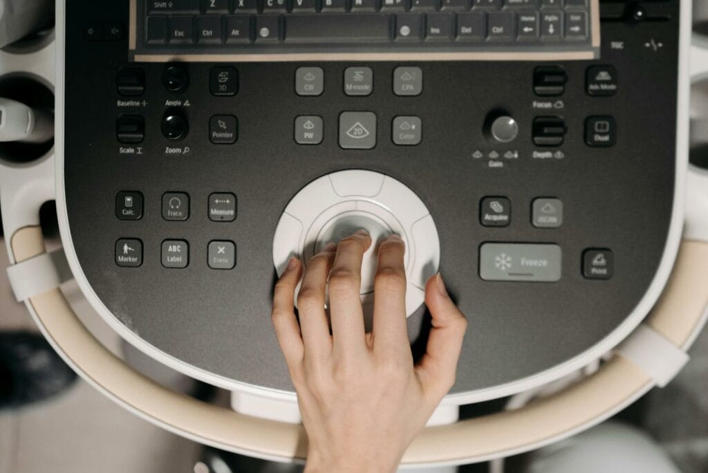 Close-Up Shot of a Person Operating an Ultrasound Machine